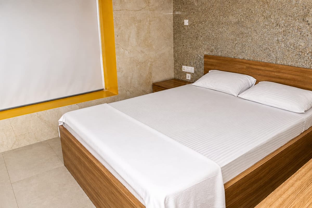 Spacious guest room with clean white bed setup
